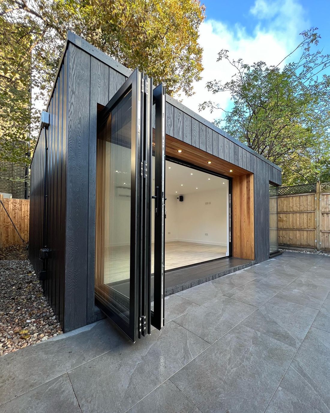 Dark clad garden room lit at dusk